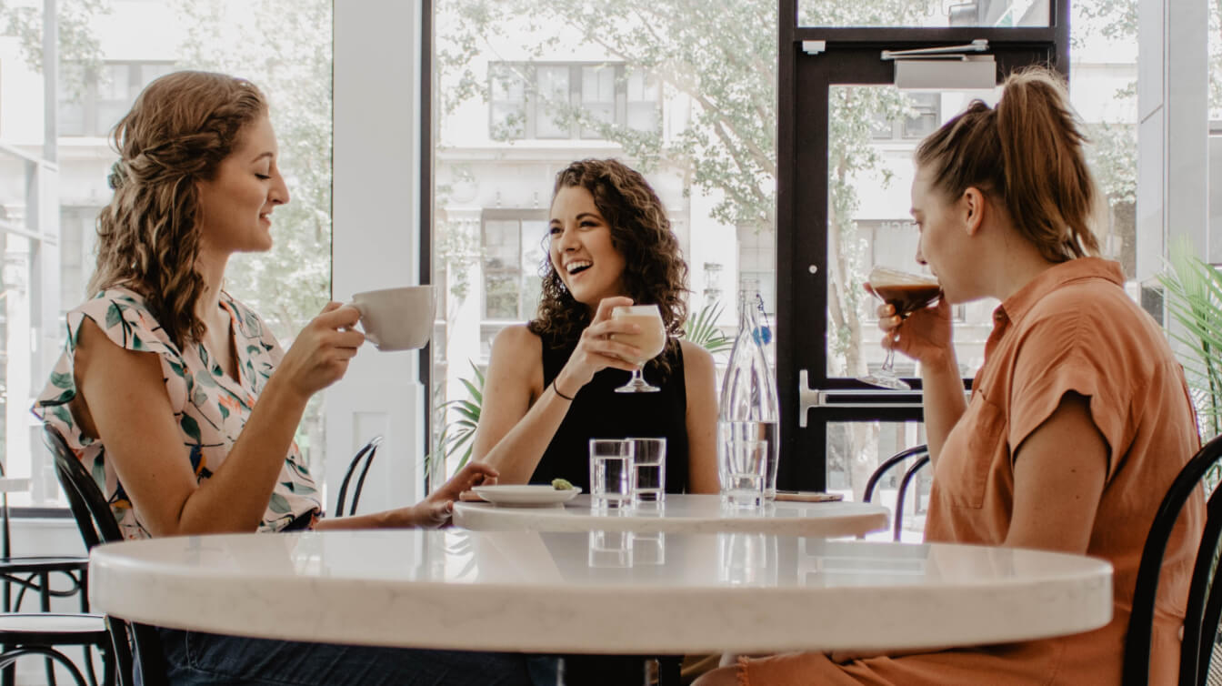 A group of ladies enjoying drinks at a restaurant