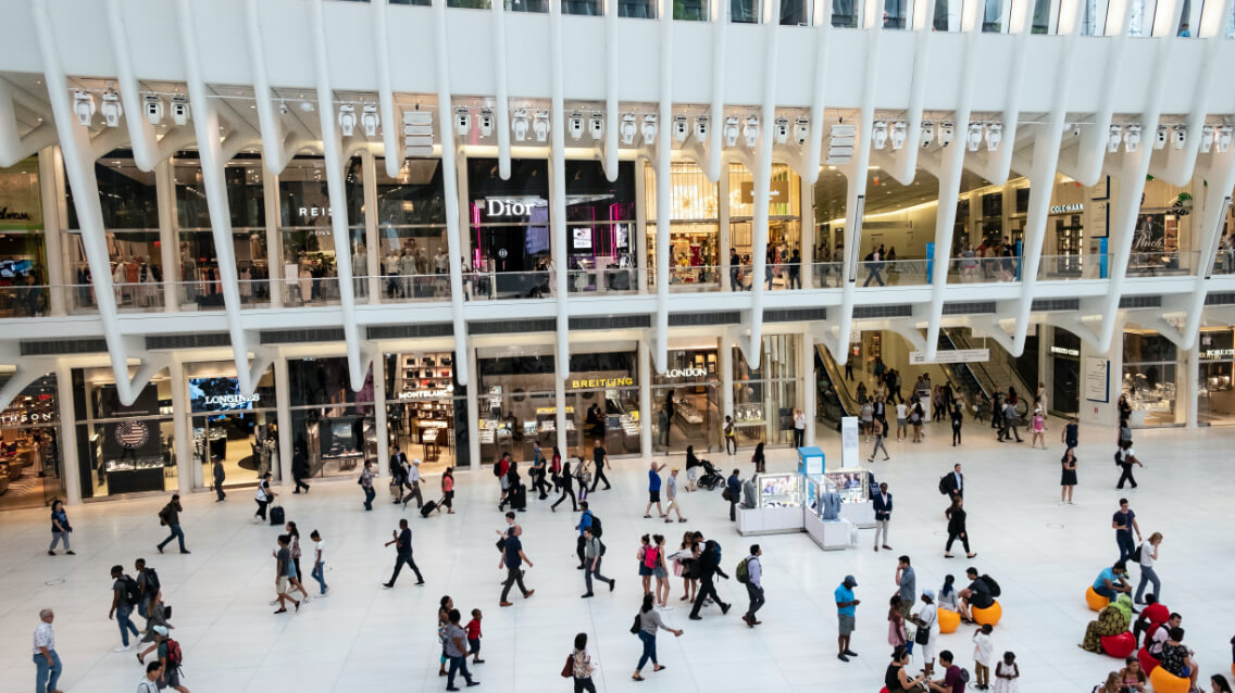Drone still of crowded mall.
